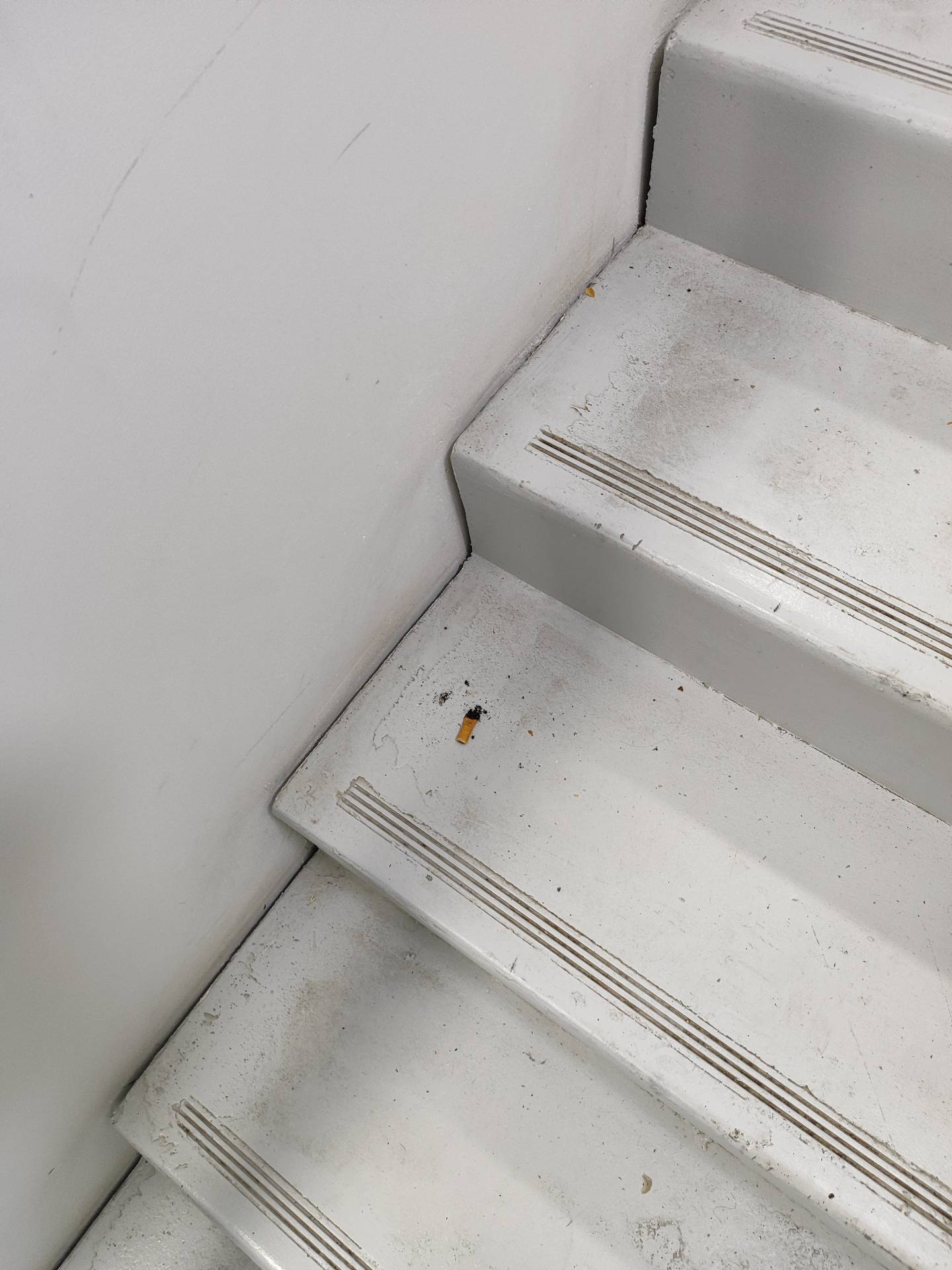 Cigarette butts in Les Clarines stairwell